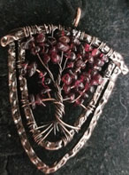 Garnet tree of life shield shape necklace with copper wire on black cord