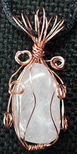 Copper wire wrapped rose quartz necklace on black cord