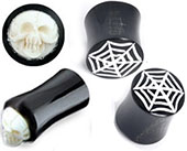 2 ga black and white horn and bone plug with either spiderweb or skull detail