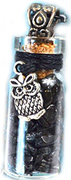 Black tourmaline chips in bottle with owl charm
